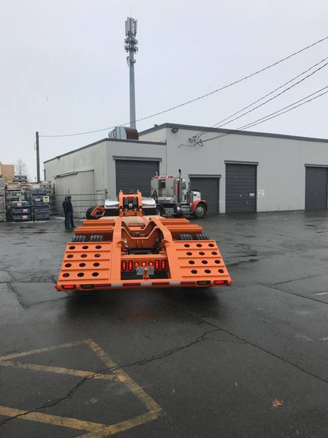 Orange tri-axle 55 ton lowbed with wood deck, hitched for winter delivery at the Pacesetter yard, photo 6 of 14