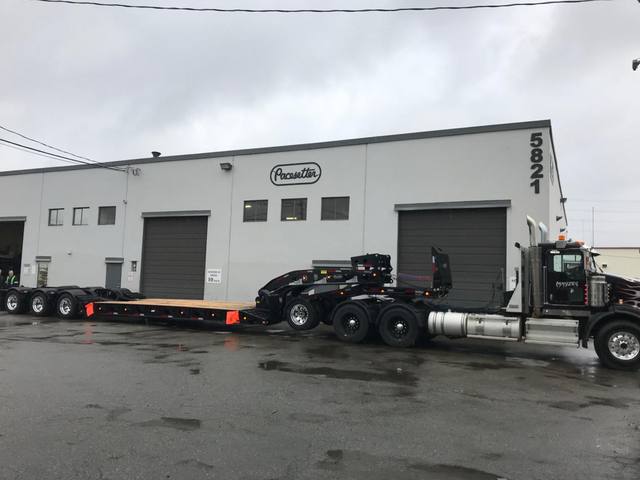 Black 60 ton lowbed with neck axle and tridem rear on a rainy day at the Pacesetter yard, photo 3 of 9