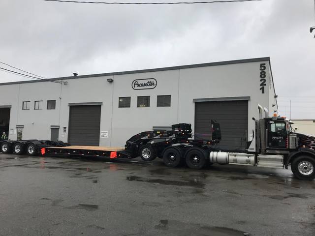 Black 60 ton lowbed with neck axle and tridem rear on a rainy day at the Pacesetter yard, photo 4 of 9