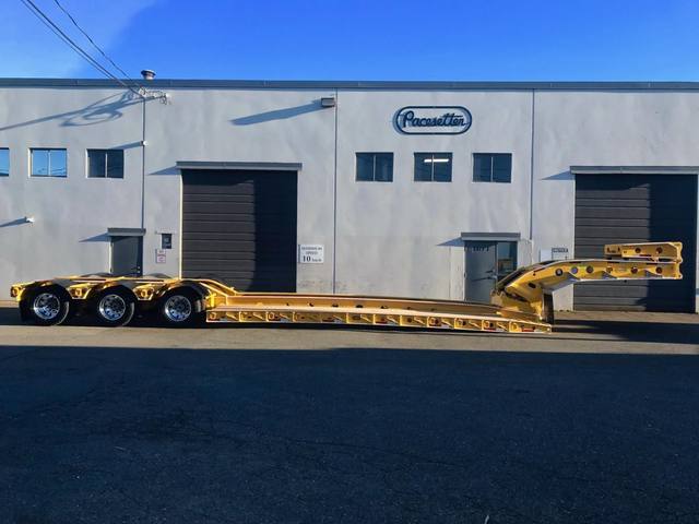 Yellow 60 ton lowbed with black fenders and a pin-on booster at the Pacesetter yard, photo 2 of 11