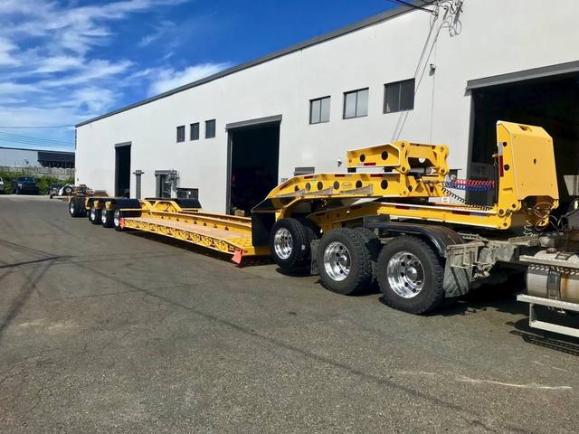 Yellow 60 ton lowbed with black fenders and a pin-on booster at the Pacesetter yard, photo 11 of 11