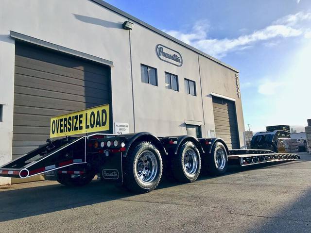 Black 65 ton lowbed with full fenders and white pinstripe edging on a sunny day, photo 4 of 7