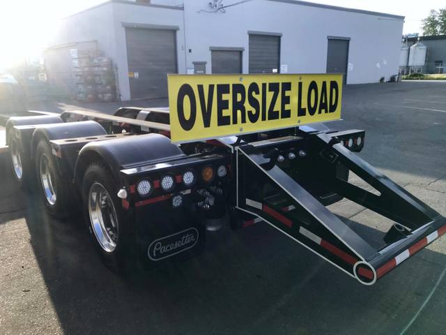 Black 65 ton lowbed with full fenders and white pinstripe edging on a sunny day, photo 5 of 7
