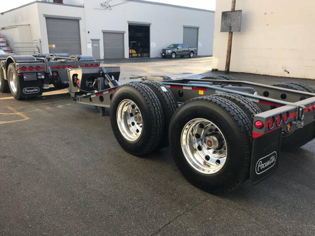 Charcoal 75 ton lowbed with light blue pinstriping and its two axle nitrogen booster, photo 19 of 26