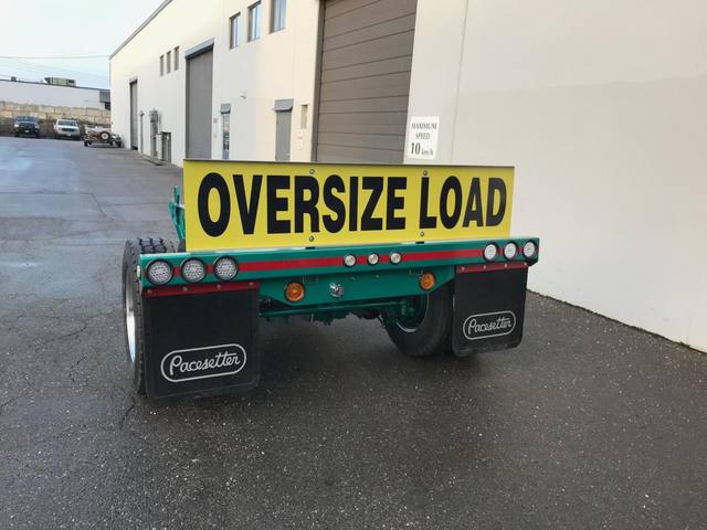 Green single axle fish mouth booster with raised coupling arms at the Pacesetter yard, photo 4 of 9