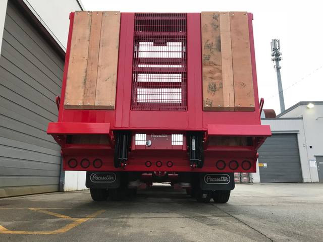 Red tri-axle paving trailer with hydraulic flip ramp at the Pacesetter plant, photo 6 of 18